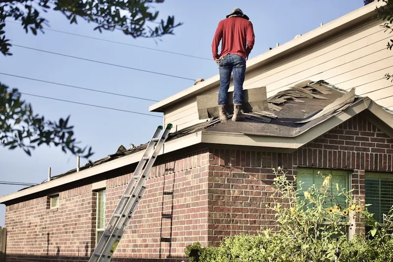 Professional roofer working on a residential roof in Grosse Pointe Woods